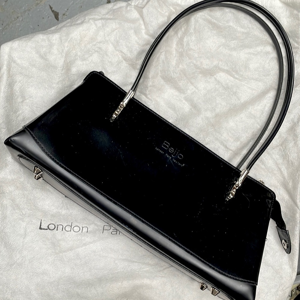 A brand new Beijo black handbag/purse. With original cover and warranty book.